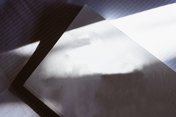 istock White book on the table. Play of light and shadow. 1941839386