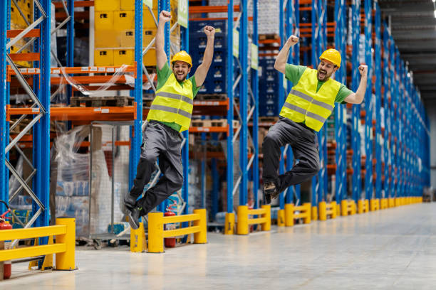 istock Warehouse workers are jumping and celebrating in facility. 1941843679