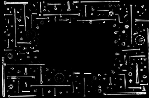 frame made of screws and nuts isolated on a black background with copy space