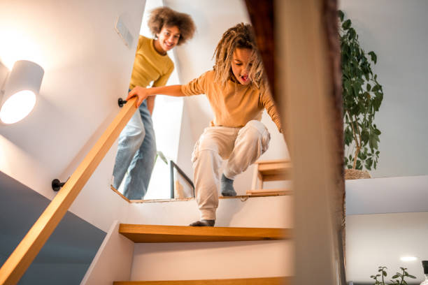 istock Mixed Race Children Playing on Staircase at Home 1941850582