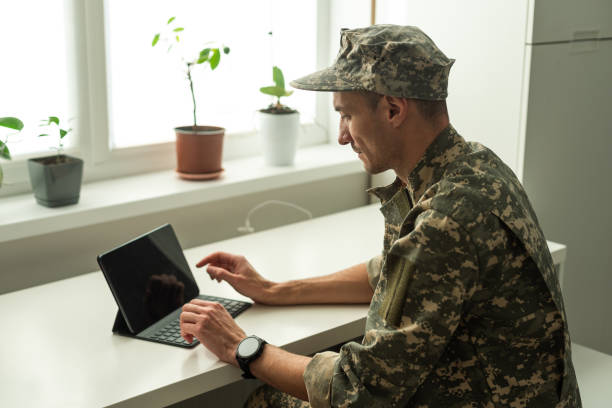 istock Happy soldier using laptop. Military service 1941855870