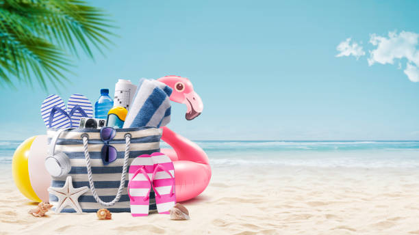 istock Beach bag and accessories on a tropical beach 1941861633