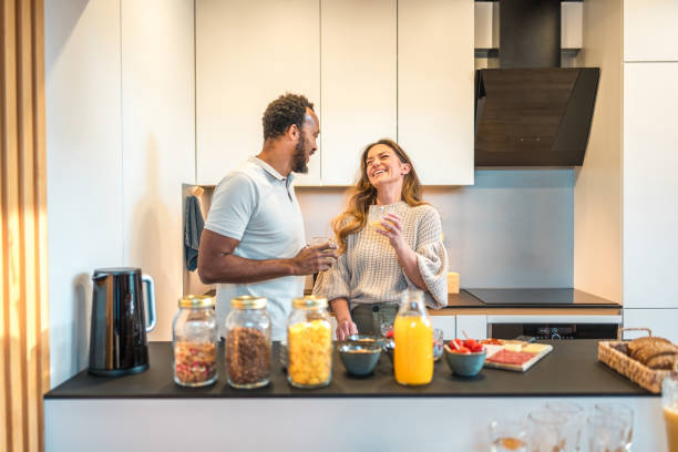 istock Diverse Couple Laughing in Kitchen 1941861638