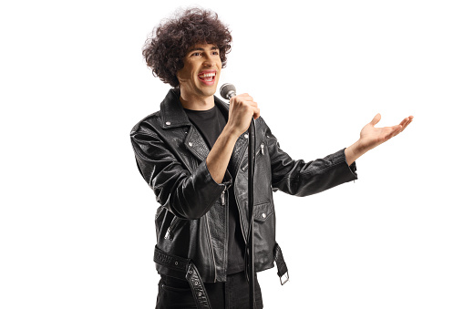 Rock male singer in a leather jacket singing on a microphone isolated on white background
