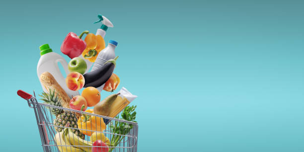 istock Groceries and goods falling in a shopping cart 1941874849