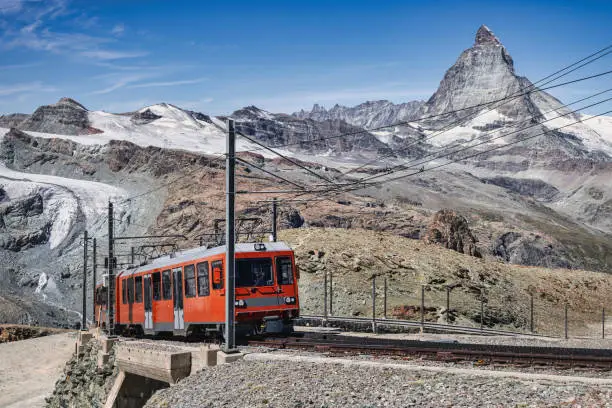 Swiss Alps in Summer with climbing, driving Gornergrat Bahn - Gornergrat Matterhorn Railway Train moving up the Mountain towards Riffelalp  - Gornergrat Mountain Top. Riffelberg, Zermatt, Switzerland, Europe.