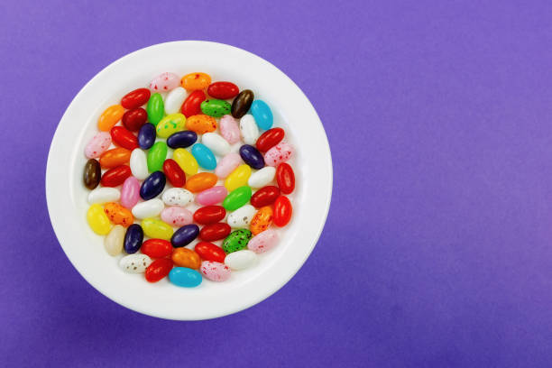 istock Assorted jelly beans on a plate on a purple background 1941881114