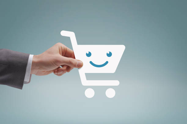 Businessman holding a smiling shopping cart icon, online shopping concept