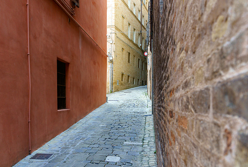 An old European-style narrow alleyway with a lamp and cobblestones from above in Prague, Czech Republic