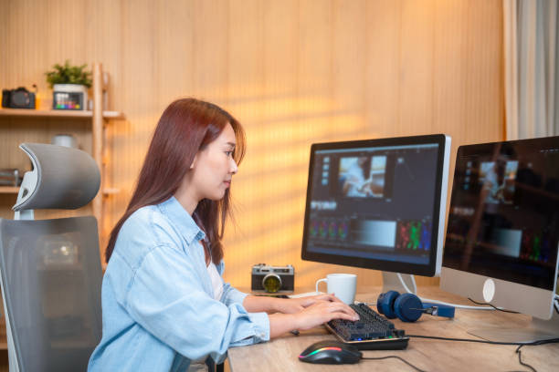 istock Beautiful Female Video Editor Works with Footage on Her Personal Computer 1941914047