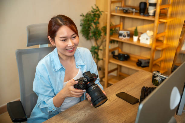 istock Young photographer working on her photos at her home office 1941914603