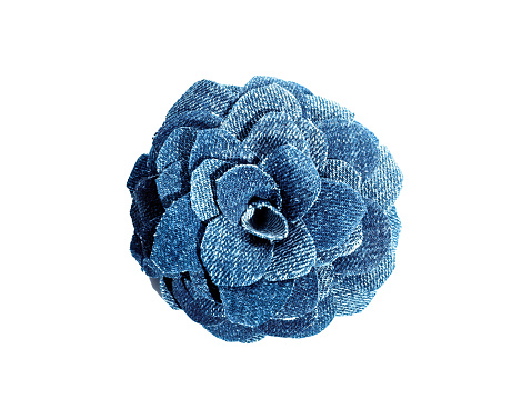 Handmade denim flower on isolated white background.