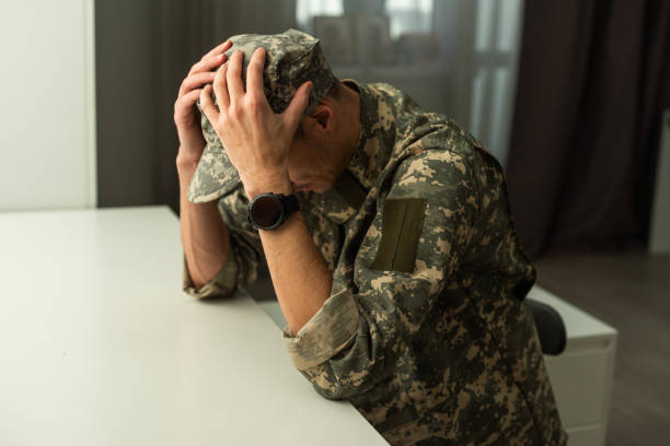 istock A distraught soldier covering his face, possibly suffering from shell shock or Post Traumatic Stress Disorder 1941930817
