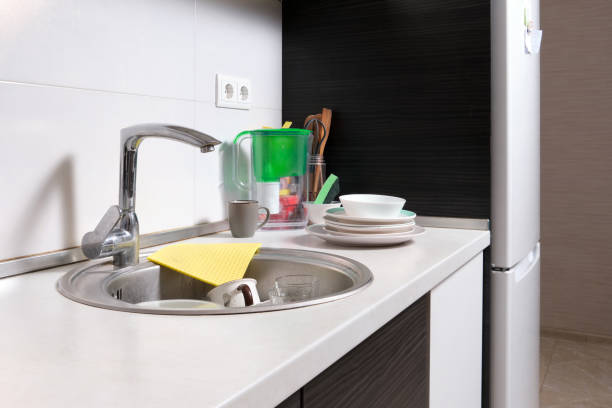 istock Work area in home kitchen with refrigerator and sink. 1941931889