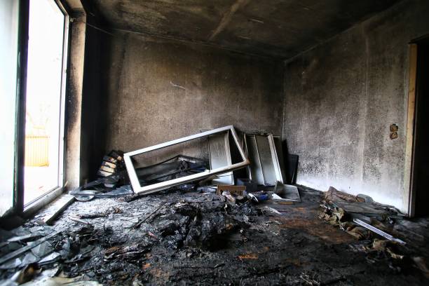 istock Burnt and destroyed room with bright daylight coming from balcony door 1941933601