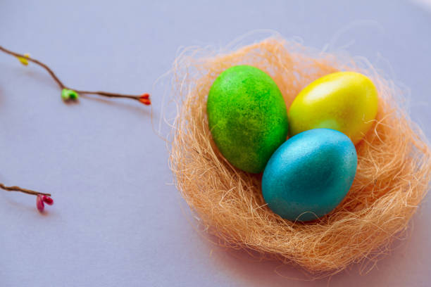 istock Easter holiday background with colored eggs in nest and space for text. 1941947119