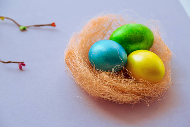 istock Easter holiday background with colored eggs in nest and space for text. 1941947129