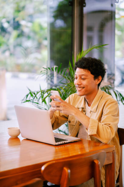 istock young adult with device 1941949282