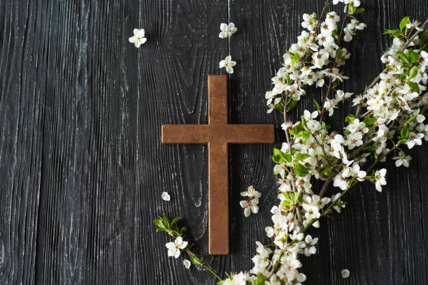 istock Cross with flowers on a wooden background 1941955190