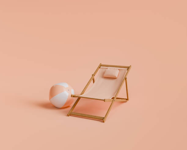 istock Beach Lounger and Ball on Peach Colored Background 1941988267