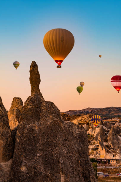 istock Hot air balloons in sunset sky 1941988284