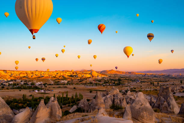 istock Hot air balloons in sky at sunset 1941988298