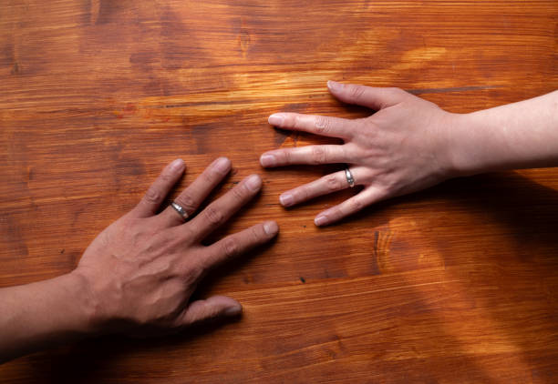 istock man and woman wearing wedding rings 1941994207