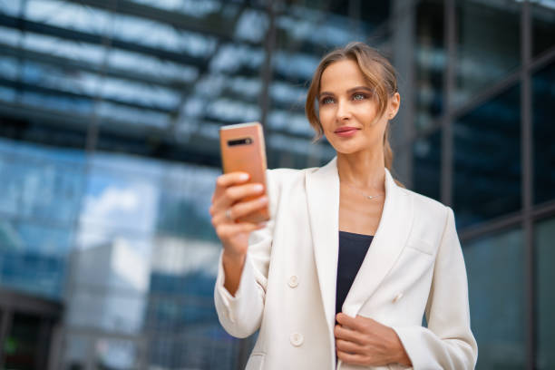 istock Business woman using her mobile phone 1941996342