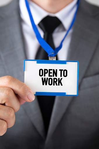 Businessman is showing his badge for open to work