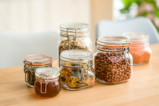 Airtight glass jars filled with healthy food on a table. High resolution 42Mp studio digital capture taken with Sony A7rII and Sony FE 90mm f2.8 macro G OSS lens