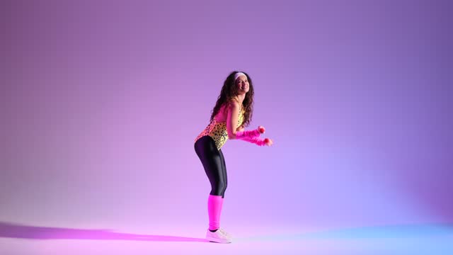 Smiling 80s Girl Doing Aerobic Workout with Dumbbells on purple background