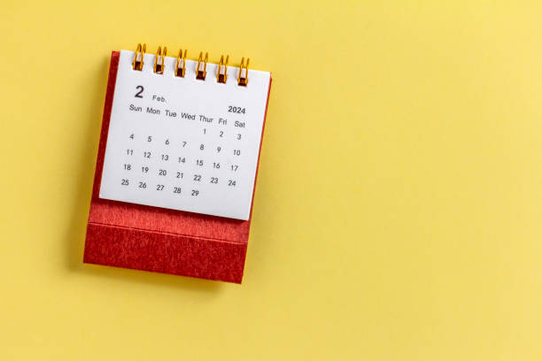 istock Desk calendar for February 2024 on a yellow background with copy space. 1942071003