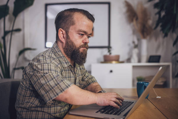 istock Satisfied Mature Man with Credit Card Ready for Online Purchase 1942082042