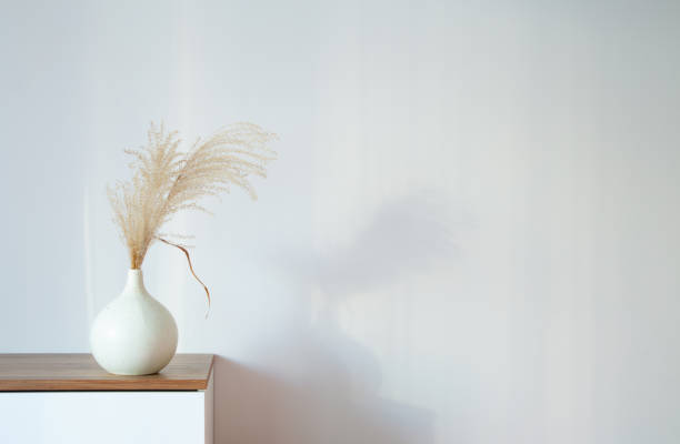 istock dry cereal ornamental plants in vase on background white wall 1942097163