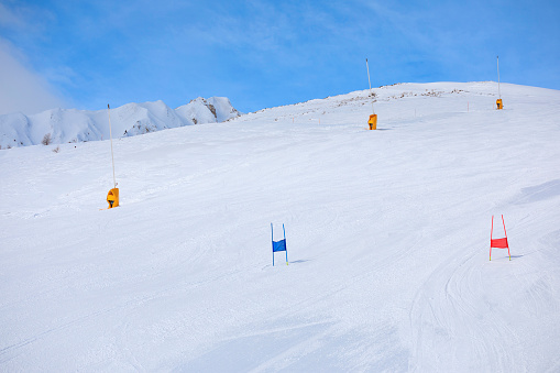 Empty ski racing course with sets of gates. Super G skiing winter sport.  Giant slalom race.  Snow skiing,   perfect ski slope, fresh prepared  piste,  ski resorts.  Snowcapped mountain  Dolomite super ski area. Ski resort. Sellaronda, italy, Europe. No People
