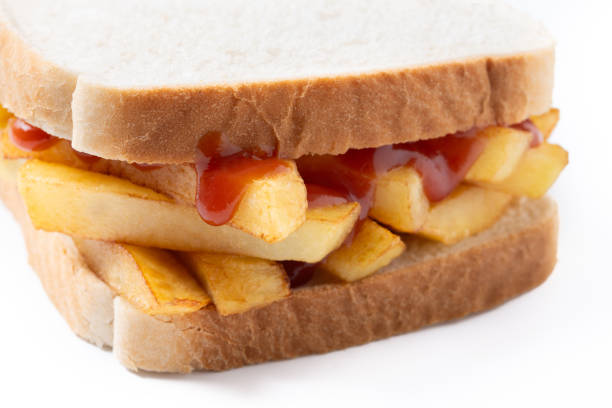 Traditional British chip butty (french fry sandwich) isolated on white background