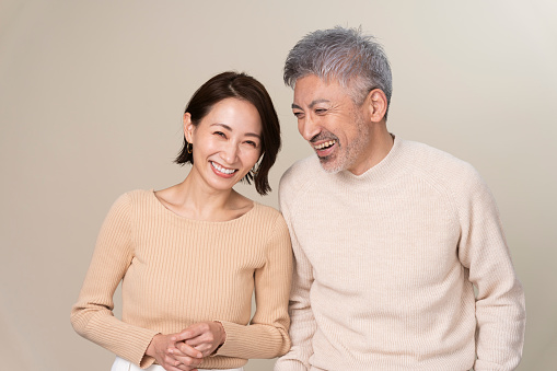 A middle-generation Japanese couple stands side by side.