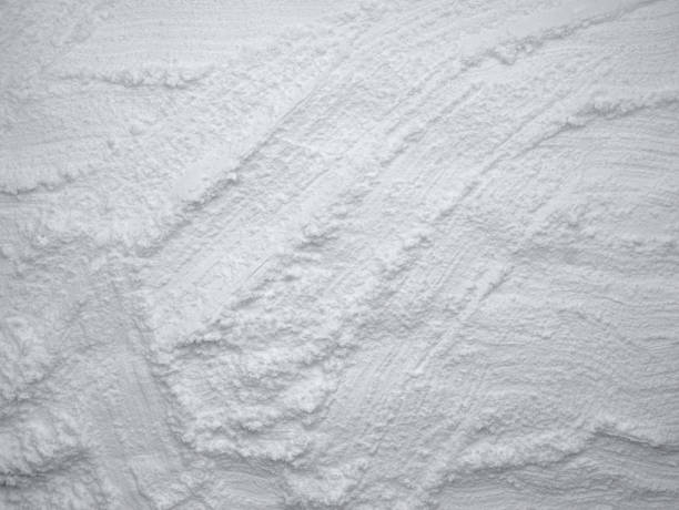 istock White flour texture background. Abstract powder texture. White powder surface with cracks. 1942132314
