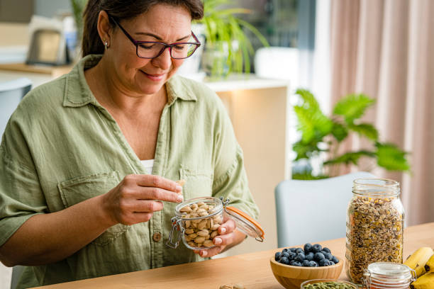 istock Woman taking organic pistachios from glass jar 1942143348