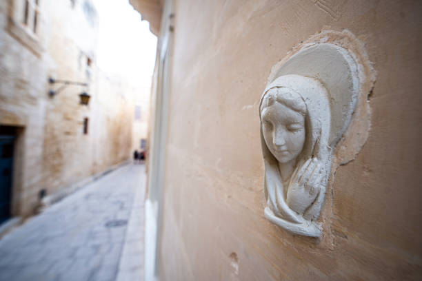 Religious Virgin Mary figure on a house wall in Malta Island.