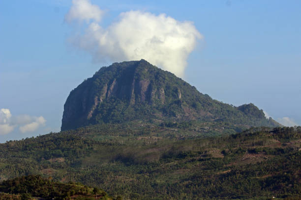 A majestic mountain called Mount Tanggul under cloudy blue sky in Tulungagung, East Java, Indonesia
