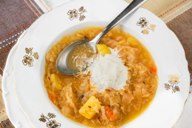istock Cabbage soup with potato, vegetable and cream in decorative plate. 1942259852