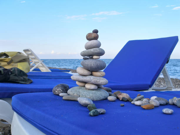 Sea pebbles piled up in pyramid on the beach