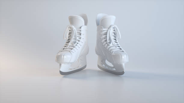 istock White Hockey Ice Skates on a Soft Grey Studio Background. Sport Concept. 1942279595