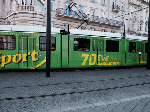 Budapest, Hungary - August 18, 2023: A tram runs along a street in Budapest downtown.