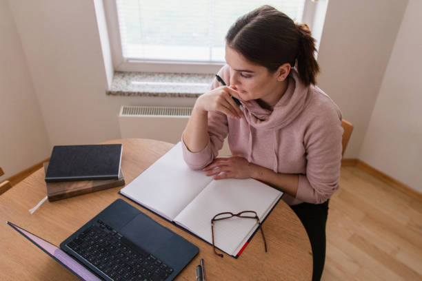 istock Young Woman Studying At Home 1942304832
