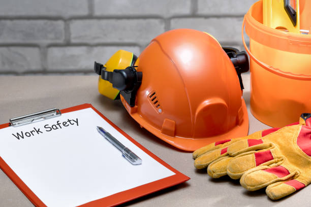 istock Work safety concept. Text work safety on the list and work safety protection equipment on workplace of builder. 1942306880