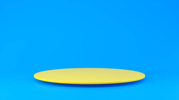 istock Yellow Thin Circle Shaped Podium With Shadow for Product Concept on a Blue Studio Background . Minimal Concept. 1942307413