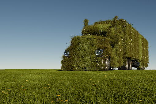 Eco friendly transportation concept. 3d rendering of a green truck on fresh spring meadow with blue sky in background - 3D Illustration