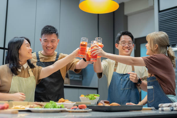 istock Asian Couples toasting in the kitchen area 1942327504